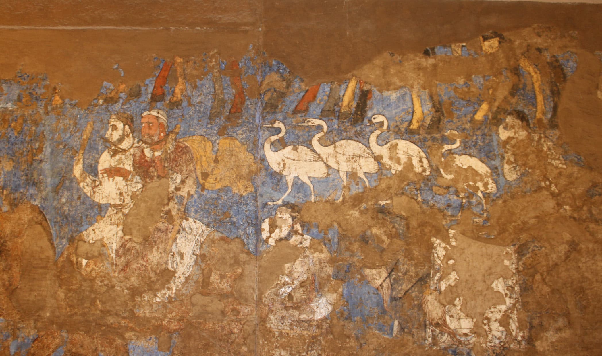A fragment of the Afrasiab wall painting: figures and white birds on a blue background