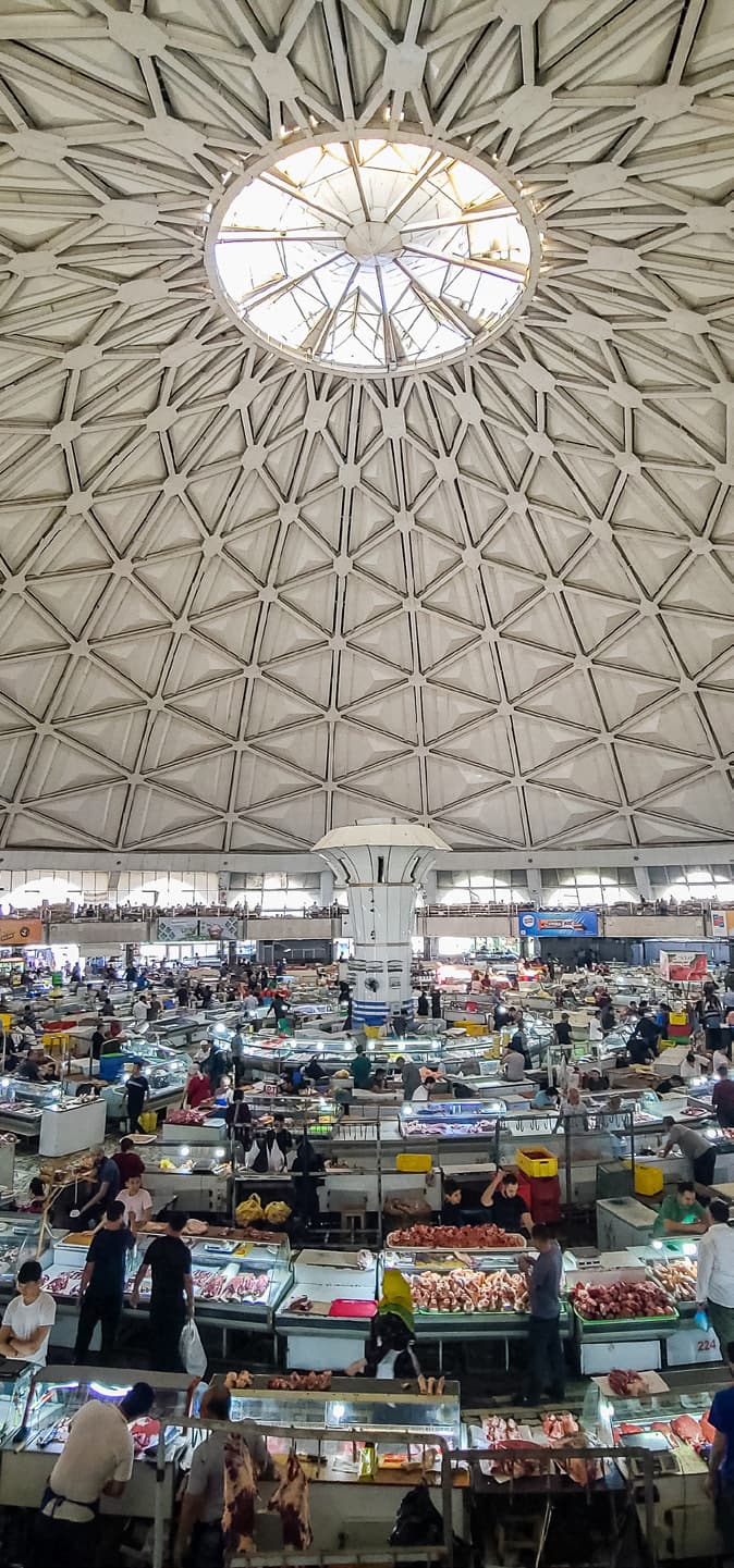 Inside Chorsu bazaar: a vast dome with a geometric lattice and a round skylight above the trading rows